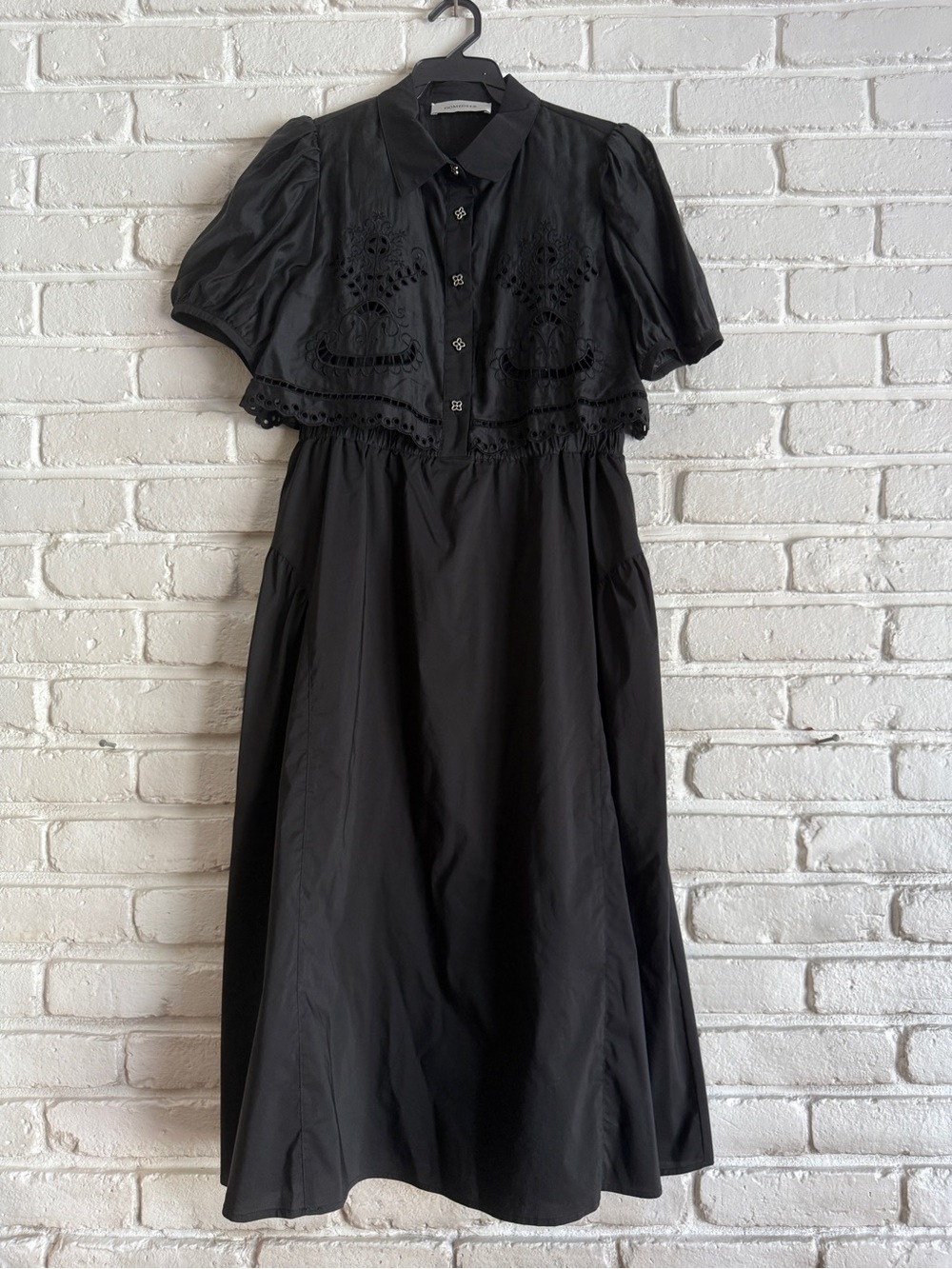 Black midi dress with lace detailing and button-up front